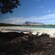 An unspoiled beach cove with a mountain in the distance